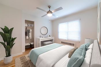 Spacious bedroom at Monon Court Apartments in Broad Ripple with large closet, ceiling fan, and space for home office near 61st Street and Compton